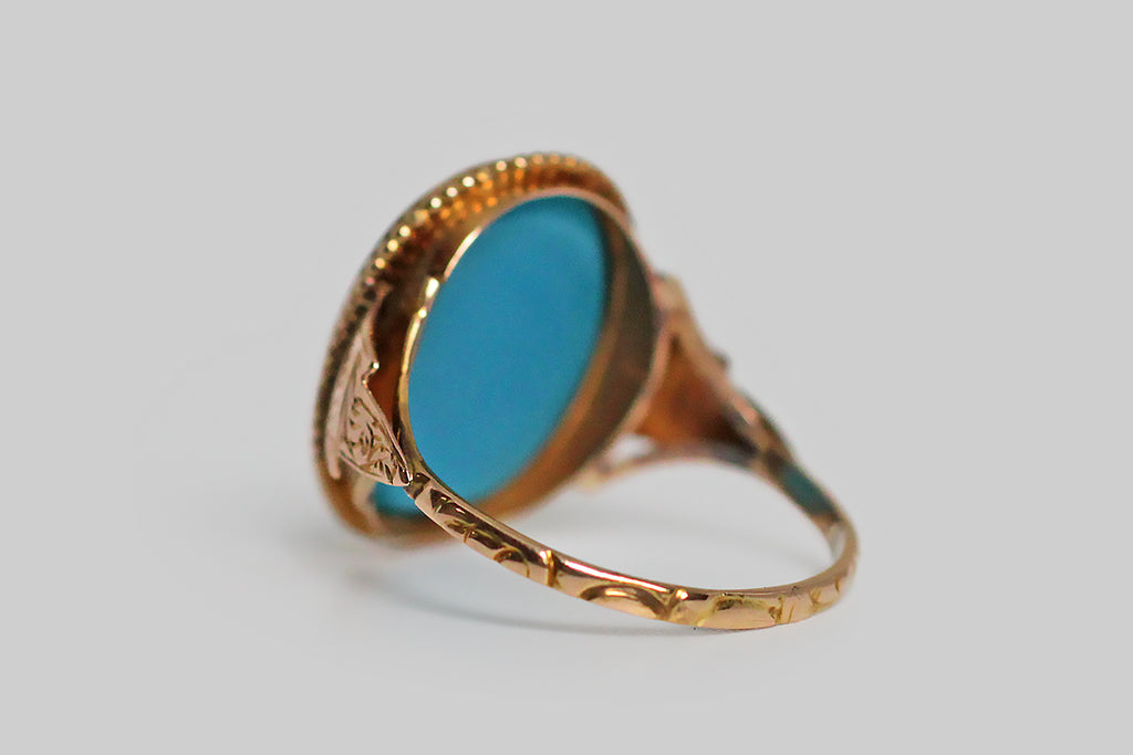 An especially rare and ephemeral Georgian era signet ring, mwhose turquoise glass intaglio seal is carved with an image of a harp, surrounded by the phrase “je reponds á qui me touche:” I respond to every touch. This beautiful old Tassie seal is still partnered with its original high karat gold ring mount. 