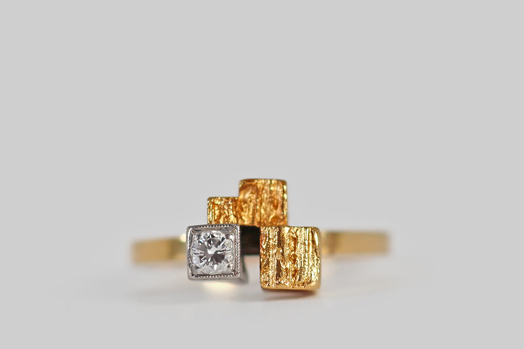 Antique Jewelry Portland, Vintage Jewelry Portland , Antique Engagement Rings | Poor Mouchette | A very cool vintage modernist ring, by the beloved design house Lapponia Finland, modeled in 18k yellow gold and platinum. This ring features a small, sparkling brilliant cut diamond (F/G, VS), which is bead-set into a deep platinum cube. This diamond-faced cube lives alongside three others, that are fashioned in yellow gold.