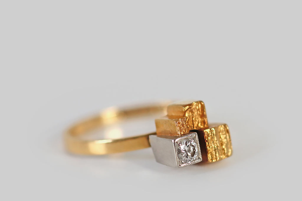 Antique Jewelry Portland, Vintage Jewelry Portland , Antique Engagement Rings | Poor Mouchette | A very cool vintage modernist ring, by the beloved design house Lapponia Finland, modeled in 18k yellow gold and platinum. This ring features a small, sparkling brilliant cut diamond (F/G, VS), which is bead-set into a deep platinum cube. This diamond-faced cube lives alongside three others, that are fashioned in yellow gold. 