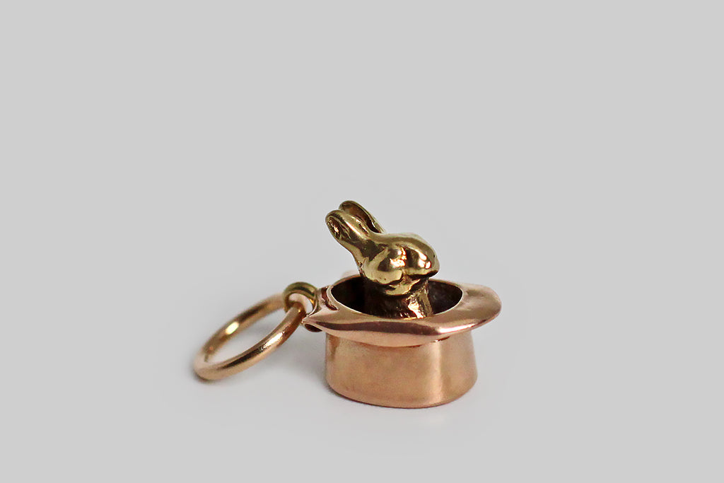 Poor Mouchette | Curated Antique Jewelry, Vintage Jewelry & Engagement Rings | Portland, Oregon | A seriously miniature, bi-color, 1940s charm, modeled in 14k rose and yellow gold, depicting a rabbit sitting inside a magician’s top hat. This tiny charm is wonderful, unusual, and its old gold surfaces are perfectly worn and buttery. Ever feel like you pulled a rabbit out of a hat? This guy is the embodiment of that idiom, and a little talisman for those of us who cherish the unexpected! 