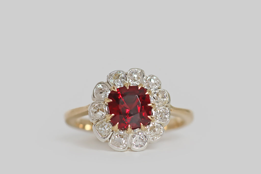 Poor Mouchette | Curated Antique Jewelry, Vintage Jewelry & Engagement Rings | Portland, Oregon | A lovely, antique, flower-form cluster ring, modeled in 18k yellow gold and silver, whose primary gem is a natural, cushion-cut red spinel (unheated, Burma). This vivid, true-red gem is held in a series of eleven tapering, claw-like prongs, where it is surrounded by eleven bezel-set, old mine cut diamonds. 