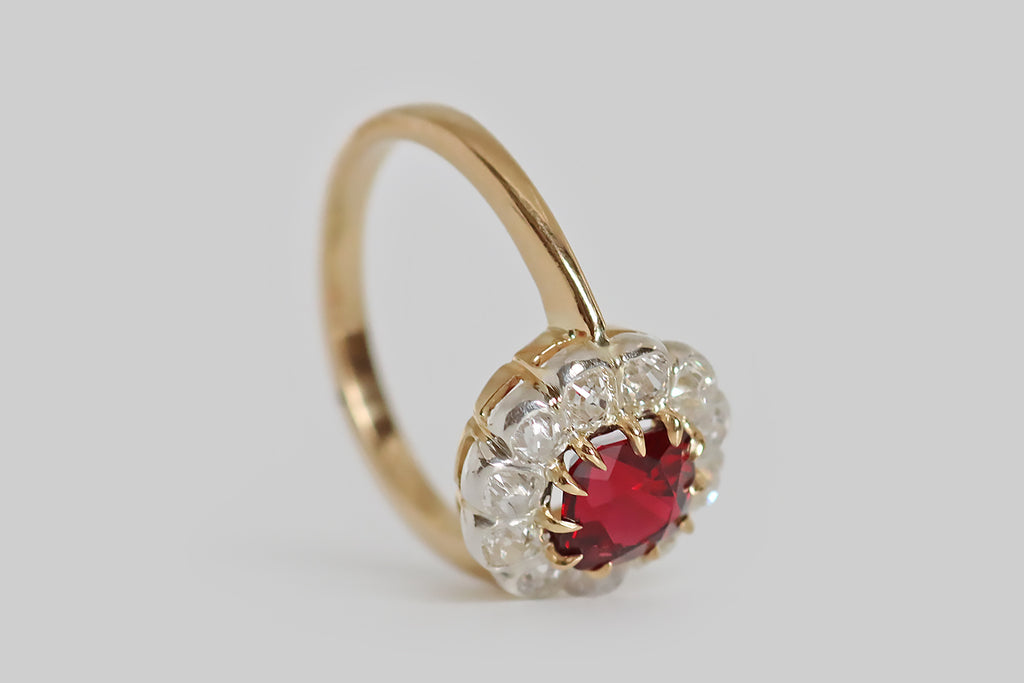 Poor Mouchette | Curated Antique Jewelry, Vintage Jewelry & Engagement Rings | Portland, Oregon | A lovely, antique, flower-form cluster ring, modeled in 18k yellow gold and silver, whose primary gem is a natural, cushion-cut red spinel (unheated, Burma). This vivid, true-red gem is held in a series of eleven tapering, claw-like prongs, where it is surrounded by eleven bezel-set, old mine cut diamonds.