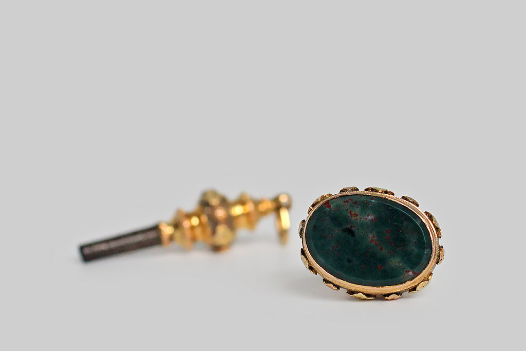 Poor Mouchette | Curated Antique Jewelry, Vintage Jewelry & Engagement Rings | Portland, Oregon | An ornate, matching, mid-Victorian, watch key and seal fob, modeled in three colors of 15k gold (yellow, rose, and green). These shapely, old friends are decorated with a series of beautifully made, applied flowers, that rest atop finely stippled fields. The seal fob is set with an un-carved bloodstone gem, whose deep green surface is speckled with bright red flecks