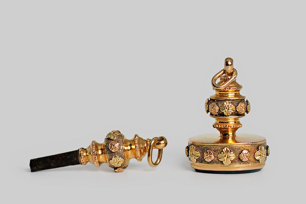 Poor Mouchette | Curated Antique Jewelry, Vintage Jewelry & Engagement Rings | Portland, Oregon | An ornate, matching, mid-Victorian, watch key and seal fob, modeled in three colors of 15k gold (yellow, rose, and green). These shapely, old friends are decorated with a series of beautifully made, applied flowers, that rest atop finely stippled fields. The seal fob is set with an un-carved bloodstone gem, whose deep green surface is speckled with bright red flecks