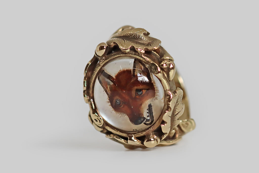 Poor Mouchette | Curated Antique Jewelry, Vintage Jewelry & Engagement Rings | Portland, Oregon | A rare and wonderful Victorian era ring, modeled in 14k yellow gold, whose gem is a hand-painted, reverse-carved, intaglio crystal, depicting the face of a red fox. This three-dimensional fox mask appears to float under a crystal dome— the manner of reverse-carving creates the illusion of depth, so that the face of our beautiful animal looks different from every angle, as he would in life.