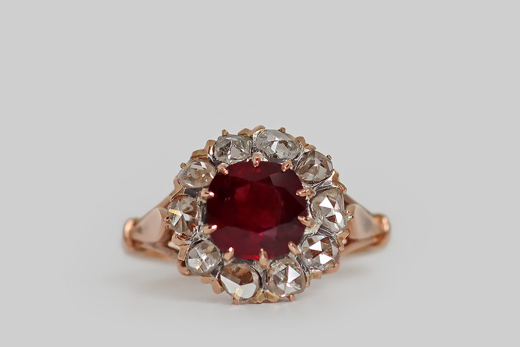 Poor Mouchette | Curated Antique Jewelry, Vintage Jewelry & Engagement Rings | Portland, Oregon | A striking, late-Victorian-era cluster ring, modeled in 18k rose gold, whose primary gemstone is a natural, untreated, 1.53 carat Burmese ruby. This vibrant, deep-red, cushion-shaped gem is held in ten claw-like prongs, where it is surrounded by a halo of ten glinting, rose cut diamonds. These soulful, hand-cut diamonds have domed faces with charming, irregular facets— they are flat-backed. 