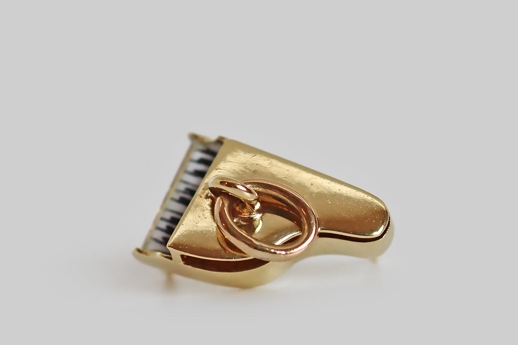 Antique Jewelry Portland, Vintage Jewelry Portland , Antique Engagement Rings | Poor Mouchette | A dainty vintage charm, modeled as a grand piano in 14k yellow gold, by the Newark jewelers Sloan & Co. This little piano is beautifully made, in three dimensions— its tiny black and white keys were hand-painted in black and white enamel, with a hair-fine brush. This old charm is a rarity. It would make a wonderful talisman for a pianist, a music student, or any music lover!