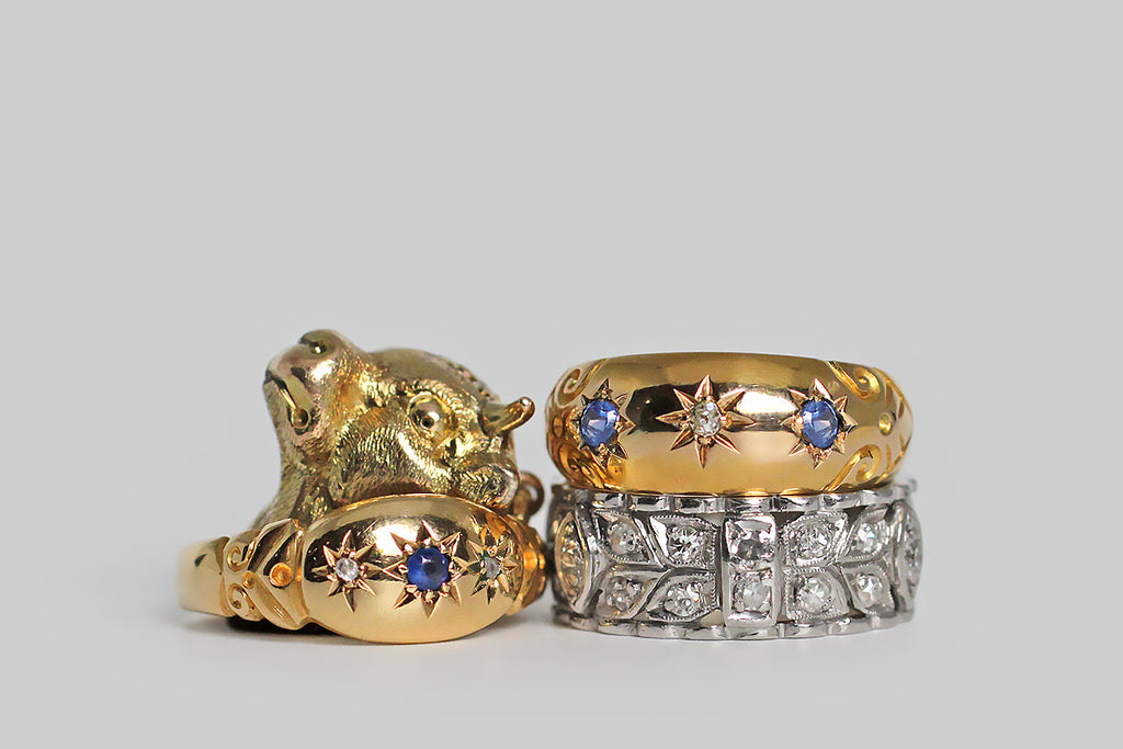 Poor Mouchette | Curated Antique Jewelry, Vintage Jewelry & Engagement Rings | Portland, Oregon | An elegant, wide, mid-20th-century, diamond-set eternity band, modeled in platinum, whose face is decorated with a balanced series of nested folate forms, interrupted, periodically by raised navette and strap-like forms. These many hand-pierced shapes are bead-set with old mine cut and single cut diamonds.