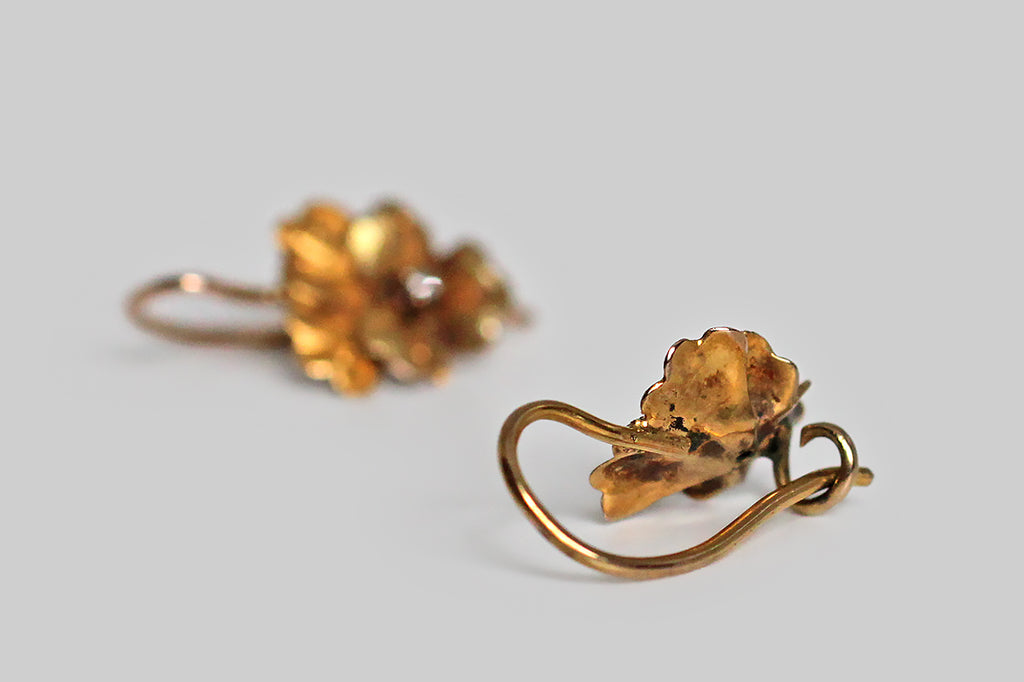 Poor Mouchette | Curated Antique Jewelry, Vintage Jewelry & Engagement Rings | Portland, Oregon | A darling pair of Victorian-era dormeuse (sleeper) earrings, modeled as miniature pansies, in 14k yellow gold. These little flowers are quite realistic, with lobed petals that bend softly, both inward and outward. The all-over, finely-stippled texture, applied to our flowers' petals, adds sparkling visual interest, while creating depth and subtle variation in color.