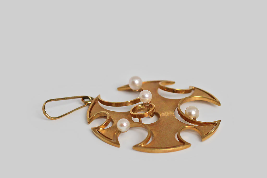 Poor Mouchette | Curated Antique Jewelry, Vintage Jewelry & Engagement Rings | Portland, Oregon | A striking, oversized, mid 20th century, modernist pendant, modeled in 18k yellow gold and set with a clutch of lustrous cultured pearls. This playful jewel is a study in circular forms— the primary shape is a large circle from whose edges smaller circles, of various sizes, have been removed. 