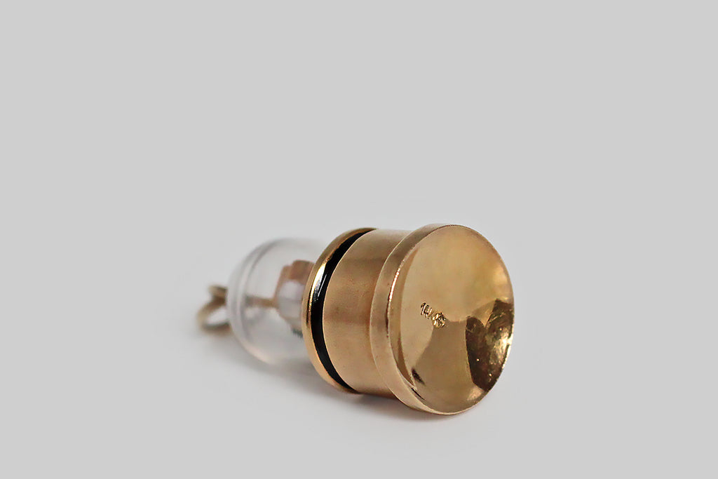 Poor Mouchette | Curated Antique Jewelry, Vintage Jewelry & Engagement Rings | Portland, Oregon | A rare mid twentieth century charm, modeled in 14k yellow gold, after the Edison ticker tape machine. This sweet, miniature stock ticker is decorated with enamel (in red, white and black), and enclosed inside a clear, bell-shaped cloche. Ticker tape machines were the earliest dedicated financial communications system— they transmitted stock price information