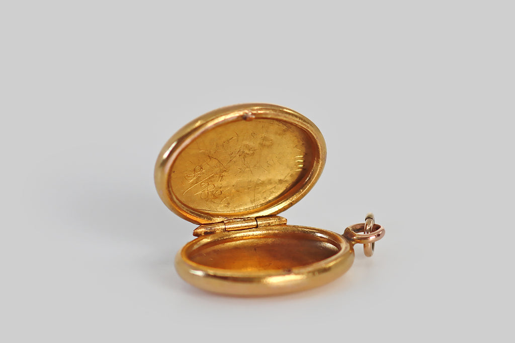 Antique Jewelry Portland, Vintage Jewelry Portland , Antique Engagement Rings | Poor Mouchette | A diminutive Victorian era locket, modeled in 18k gold, whose oval face is decorated with applied lily of the valley decor. This decoration consists of four nodding platinum blossoms that hang from a rose gold stem, a pair of green gold leaves that are posted at the base of the flower, and deeply engraved springs of meadow grass that fill out the little scene.