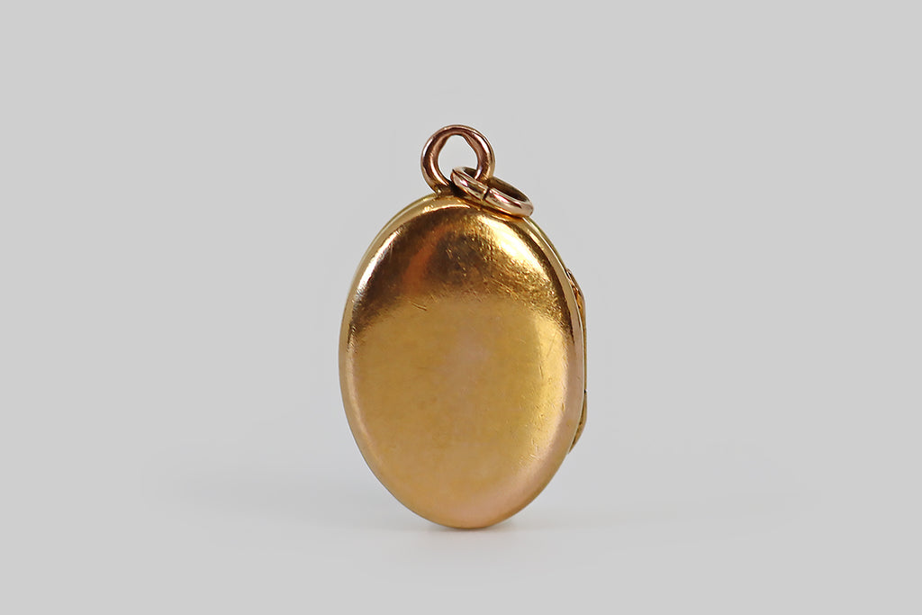Antique Jewelry Portland, Vintage Jewelry Portland , Antique Engagement Rings | Poor Mouchette | A diminutive Victorian era locket, modeled in 18k gold, whose oval face is decorated with applied lily of the valley decor. This decoration consists of four nodding platinum blossoms that hang from a rose gold stem, a pair of green gold leaves that are posted at the base of the flower, and deeply engraved springs of meadow grass that fill out the little scene.