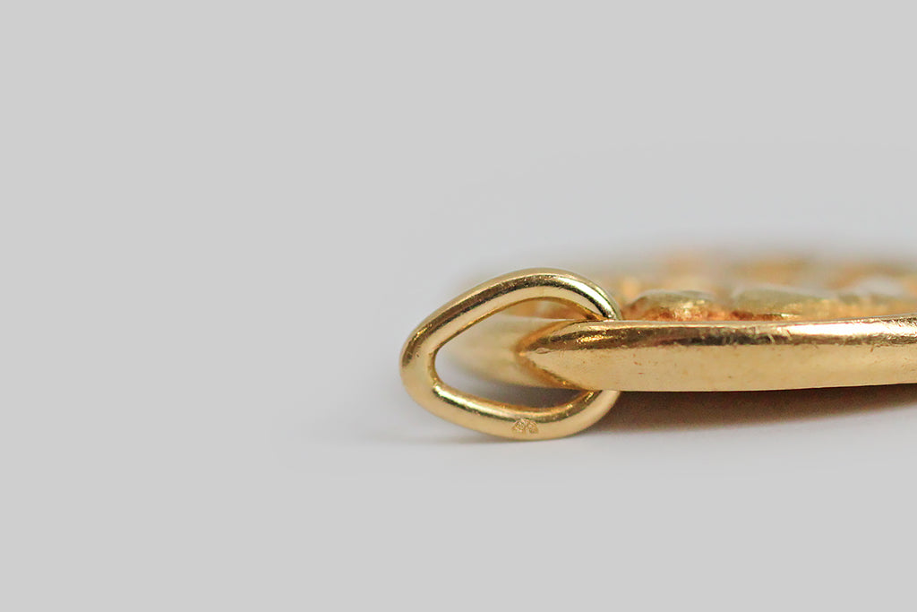 An iconic vintage zodiac pendant by Van Cleef & Arpels. This gemini pendant, and the other designs in this 1960s - 1970s zodiac series, was made to recall an ancient roman coin, with the slightly craggy textural qualities you would except to find in something ancient, and with small nicks in the edges that are integral to the design. 