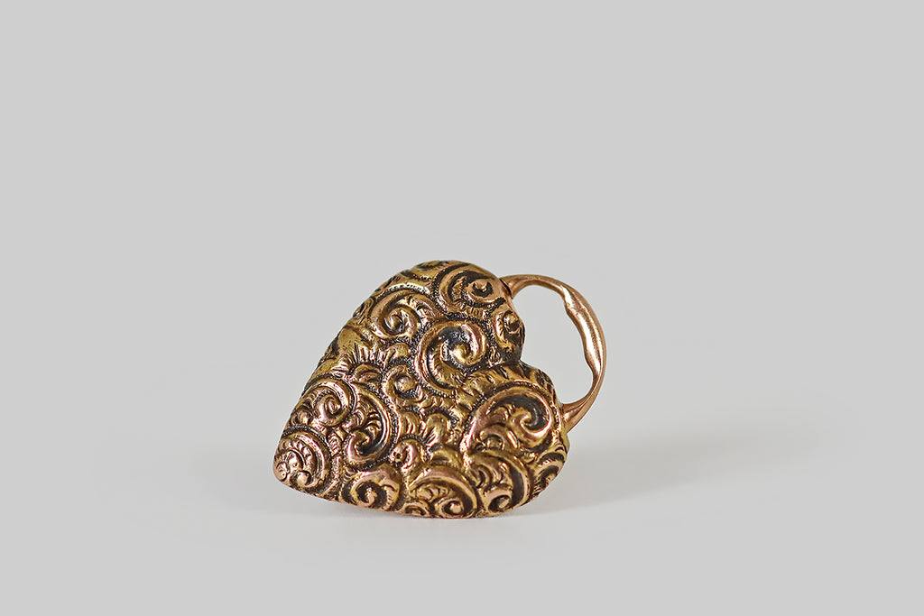 Antique Jewelry Portland, Vintage Jewelry Portland , Antique Engagement Rings | Poor Mouchette | A lovely Victorian-era, repoussé heart padlock, modeled in 14k yellow gold, that is still partnered with its original 14k gold key! This antique charm is a functioning lock, and it is in wonderful condition. The heart-shaped lock is decorated all-over with flowers and fine, swirling, baroque forms, and the key's top echos this motif.