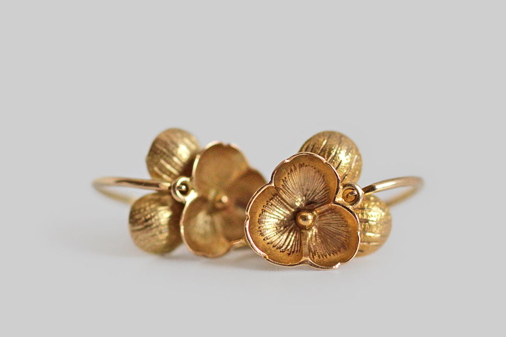 A darling pair of Victorian-era, back-to-front threading dormeuse pansy earrings, made in 18k yellow gold. These miniature flowers are quite realistic, with concave and convex forms, as well as engraved and textural details, that give them striking dimensionality. 