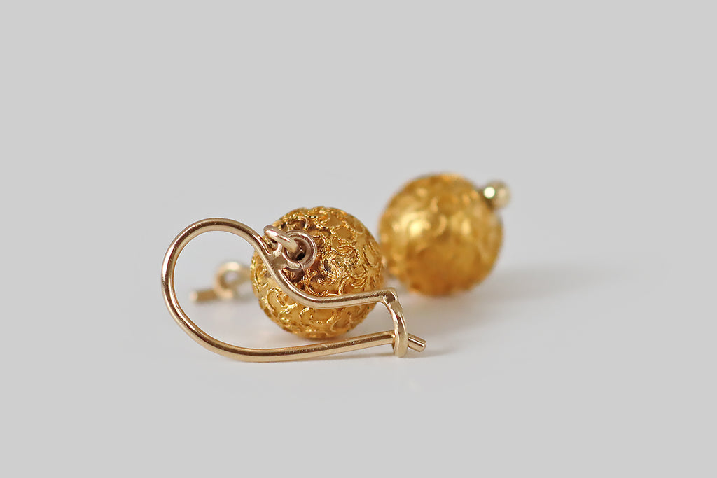 Poor Mouchette | Curated Antique Jewelry, Vintage Jewelry & Engagement Rings | Portland, Oregon | A sweet pair of Victorian era orb earrings, modeled in 15k yellow gold and decorated with applied wirework, in the Etruscan style. This twisted wire decor presents as a somewhat unruly, confetti-like collection of apostrophes populating the surface of each orb— they are cheerful and casually arranged