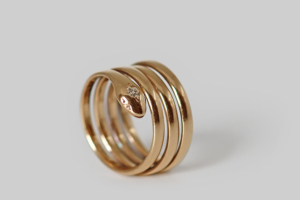 Antique Jewelry Portland, Vintage Jewelry Portland , Antique Engagement Rings | Poor Mouchette | An extra-charming Victorian era snake ring, made from one continuous, coiling, 14k gold band, which wraps the wearer’s finger four times. This rosy yellow-gold snake has sweet, subtle face details— he rests his diamond-set head atop his coiled body, and he has a little, trailing, whip-like tail.