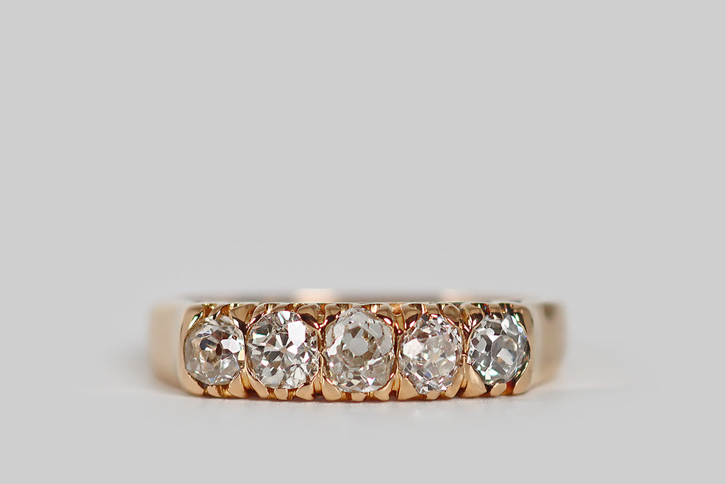 Antique Jewelry Portland, Vintage Jewelry Portland , Antique Engagement Rings | Poor Mouchette | A lovely Victorian era row ring, modeled in 18k gold, whose five, chunky old mine cut diamonds are held in a series of modified prongs, which are integral to the ring's decoratively pierced gallery. These unique hand-cut diamonds are slightly oval, with steep crown facets, small tables, and open culets