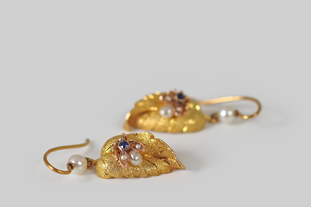Antique Jewelry Portland, Vintage Jewelry Portland , Antique Engagement Rings | Poor Mouchette | A pair of antique, Victorian-era earrings, each modeled in 14k gold as a curling leaf, upon which a small housefly rests. These leaves are gracefully and realistically rendered, with bright-line veins and fine all-over stippling that communicates a leaf's delicate, celled texture. 