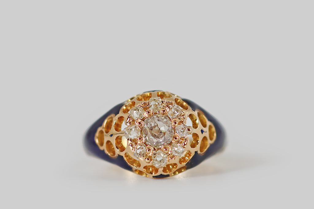 Antique Jewelry | Vintage Jewelry | Antique Engagement Rings | Portland, OR | Poor Mouchette A beautiful, enameled, Victorian-era, diamond cluster ring, modeled in 18k yellow gold, whose nine old mine cut diamonds form a subtle flower shape at the center of the ring face. This diamond flower is surrounded by a honeycomb of open circles