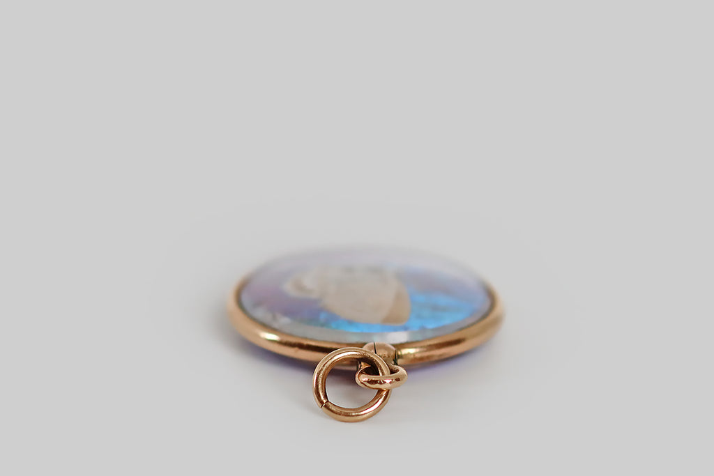 Antique Jewelry Portland, Vintage Jewelry Portland , Antique Engagement Rings | Poor Mouchette | An especially lovely Victorian-era double-sided locket, modeled in 14k yellow gold, that frames a painterly section of morpho butterfly wing on one side, and a delicate pressed moth on the other. The little white moth lays atop the vibrant, iridescent, turquoise-blue field created by the morpho wing.