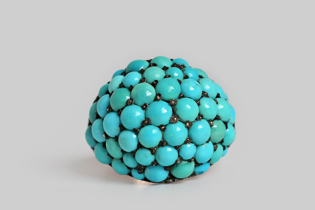 Poor Mouchette | Curated Antique Jewelry, Vintage Jewelry & Engagement Rings | Portland, Oregon | A wonderful, Victorian era bombé ring, pavé-set with fifty-three natural turquoise cabochons. These variegated, blue-green, turquoise gems are held in place by charming, irregular beads that retain their time-won, blackened patina. The ring's silver head is backed by a 10k rose gold sleeve, and its heavy, half-round shank is also fabricated in 10k rose gold. This ring is an extra-large