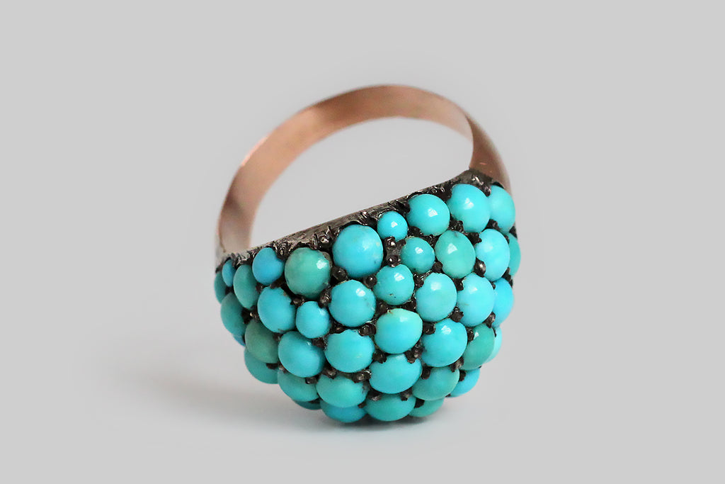 Poor Mouchette | Curated Antique Jewelry, Vintage Jewelry & Engagement Rings | Portland, Oregon | A wonderful, Victorian era bombé ring, pavé-set with fifty-three natural turquoise cabochons. These variegated, blue-green, turquoise gems are held in place by charming, irregular beads that retain their time-won, blackened patina. The ring's silver head is backed by a 10k rose gold sleeve, and its heavy, half-round shank is also fabricated in 10k rose gold. This ring is an extra-large