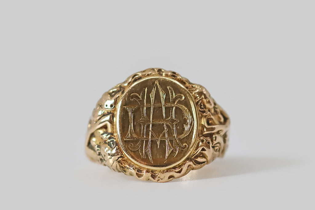 Antique Jewelry Portland, Vintage Jewelry Portland , Antique Engagement Rings | Poor Mouchette | A weighty Edwardian era signet ring, modeled in 14k yellow gold (with a classic tapering profile) whose shoulders feature a highly-detailed, high-relief carving of a lounging maiden and a dragon.