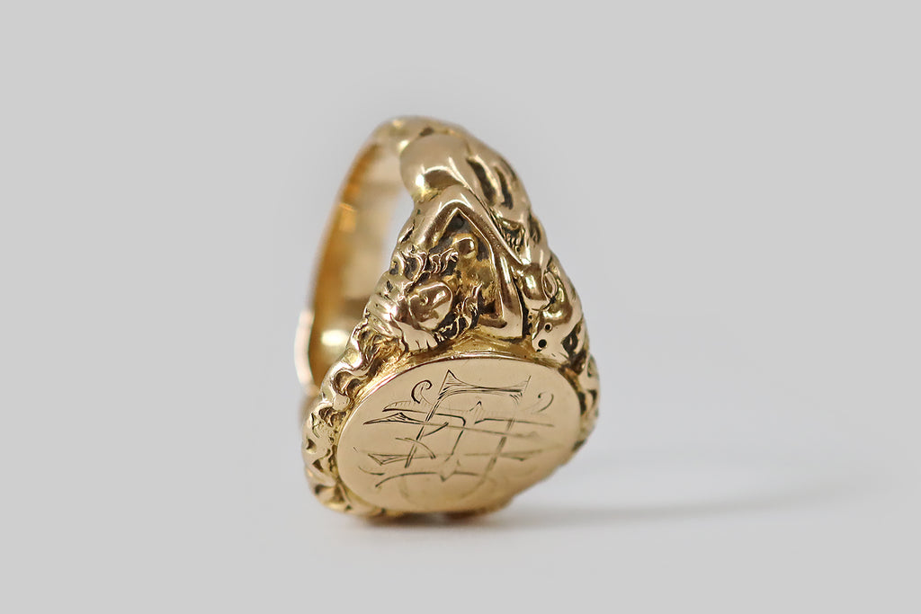 Antique Jewelry Portland, Vintage Jewelry Portland , Antique Engagement Rings | Poor Mouchette | A weighty Edwardian era signet ring, modeled in 14k yellow gold (with a classic tapering profile) whose shoulders feature a highly-detailed, high-relief carving of a lounging maiden and a dragon.