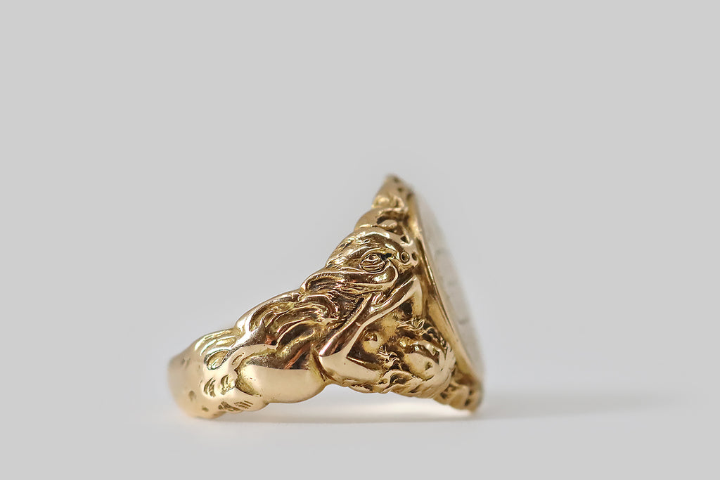 Antique Jewelry Portland, Vintage Jewelry Portland , Antique Engagement Rings | Poor Mouchette | A weighty Edwardian era signet ring, modeled in 14k yellow gold (with a classic tapering profile) whose shoulders feature a highly-detailed, high-relief carving of a lounging maiden and a dragon.