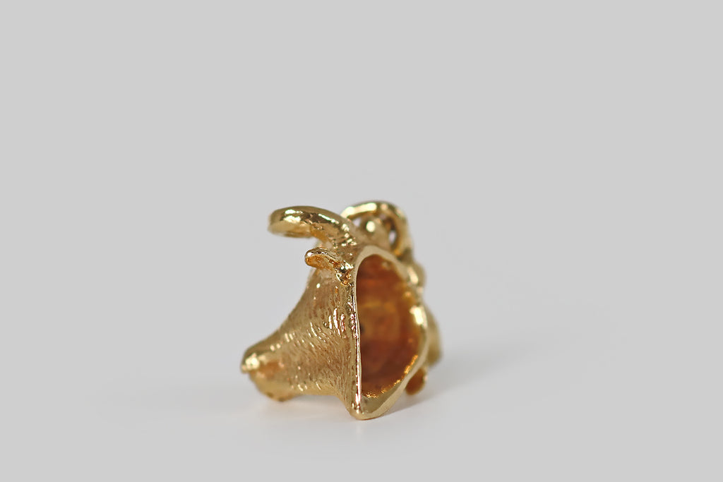 Antique Jewelry Portland, Vintage Jewelry Portland , Antique Engagement Rings | Poor Mouchette | A very sweet vintage charm, modeled realistically as a bull's head, in 18k yellow gold. This little bull's prominent horns curl above his soft ears. He has a long snout, and a tapering neck. The carving is highly-textured and expressive!