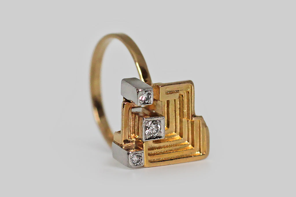 A striking Mid-20th-century, Modernist ring, modeled in 18k gold, by the well-loved Finnish designer Bjorn Weckstrom, for Lapponia. Weckstrom's jewelry is both earthy and intellectual— this design is called Sun Temple. The ring’s sculptural head closely resembles the chemical element bismuth, which occurs in these amazing stair-step forms; it also calls to mind the ruins of the grand Mayan temples that give the design its name. 